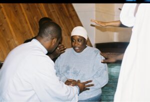 Outstretched hands praying over baptism
